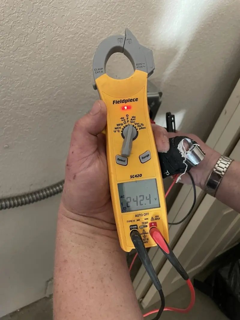 Voltage testing with clamp meter during Electrical Installation Services in New Baltimore